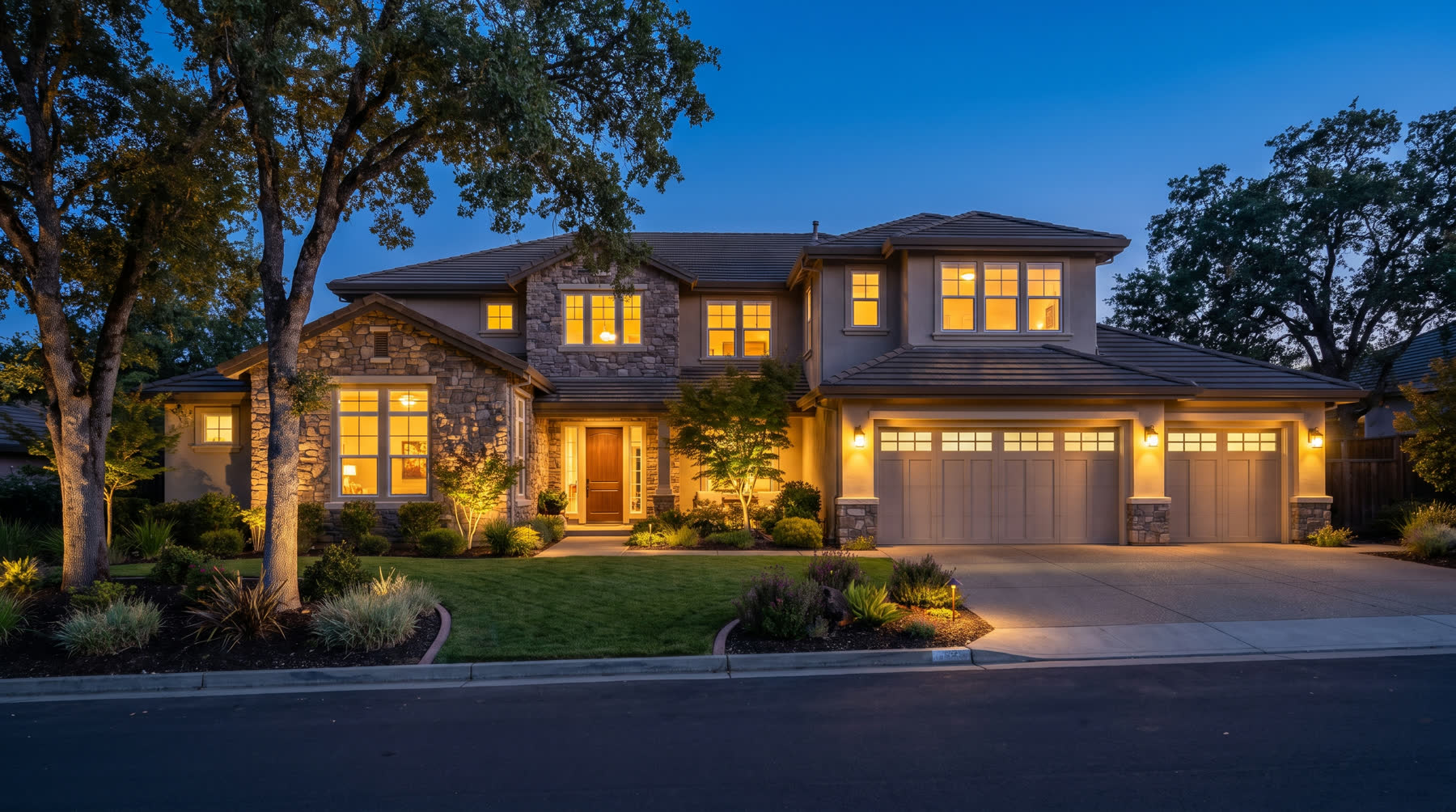 Northern California home at dusk with warm interior lighting